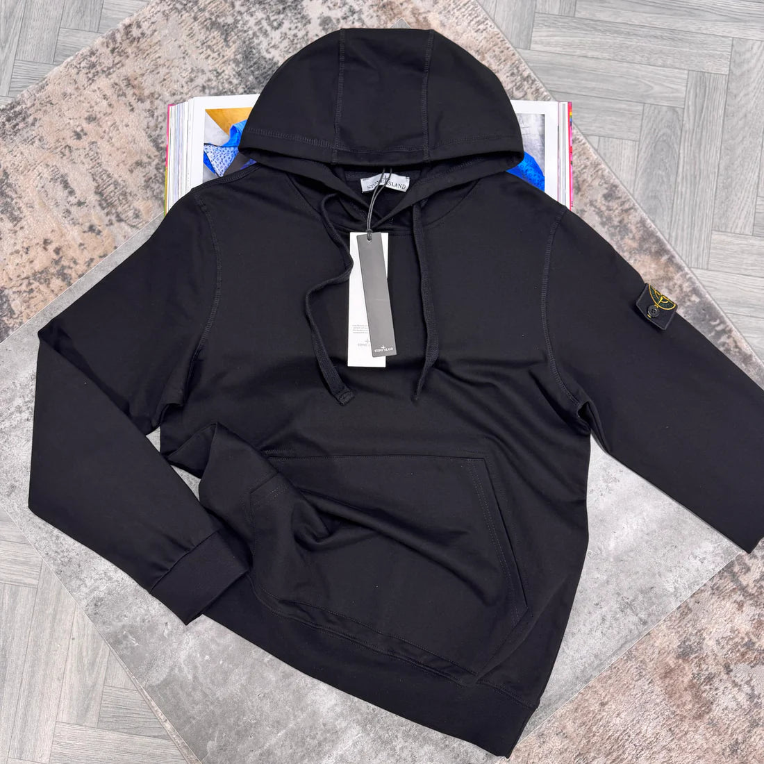 Black hoodie with logo in the sleeve