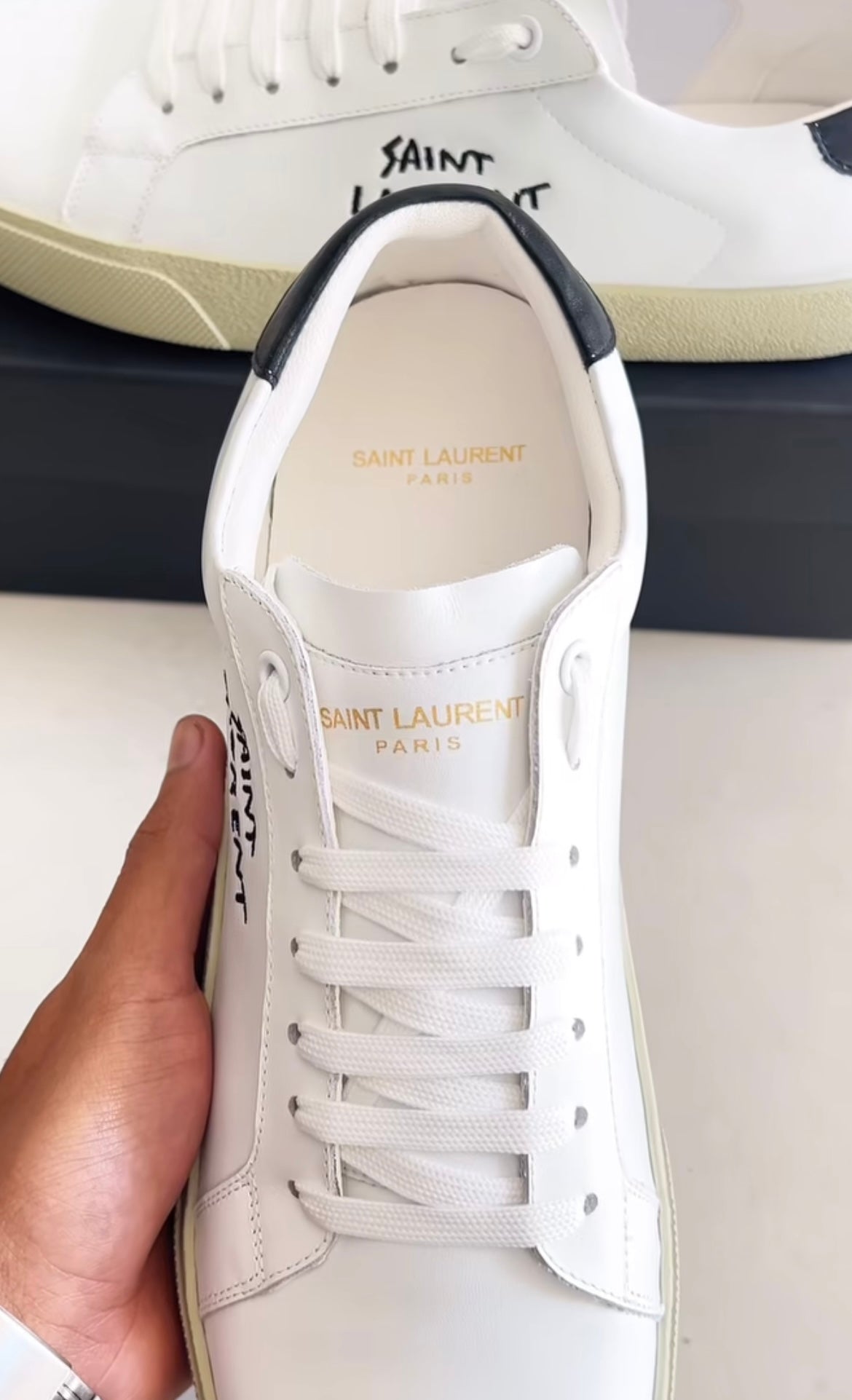 White shoes with brand logo in black