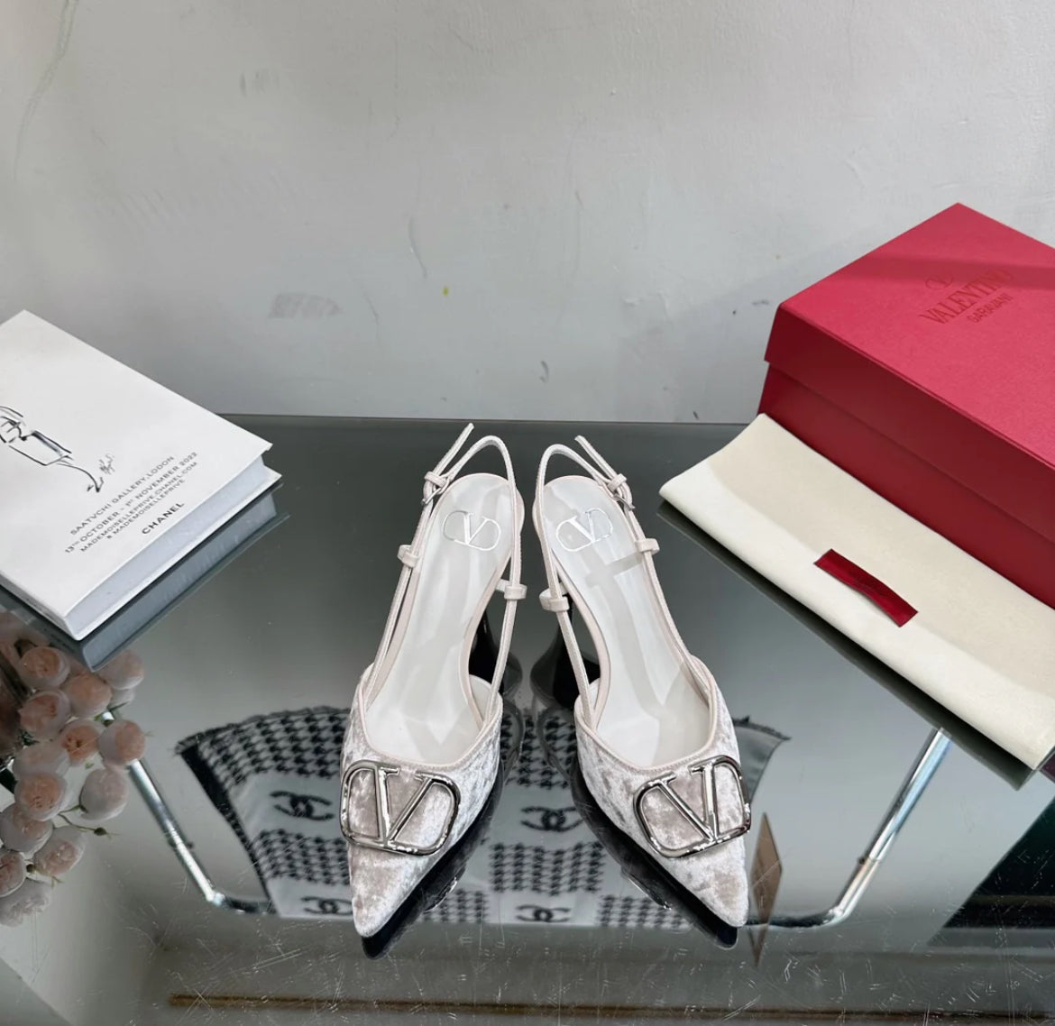 Grey heels with metallic logo on the toe