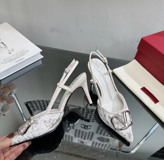 Grey heels with metallic logo on the toe