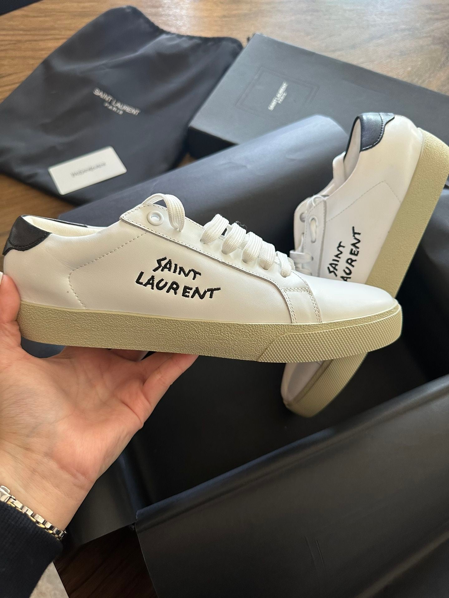 White shoes with brand logo in black