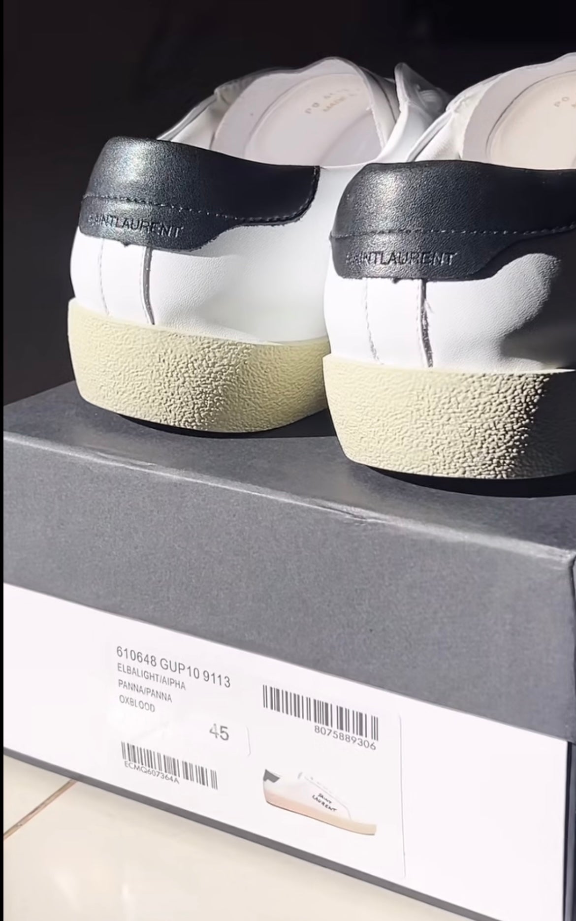 White shoes with brand logo in black