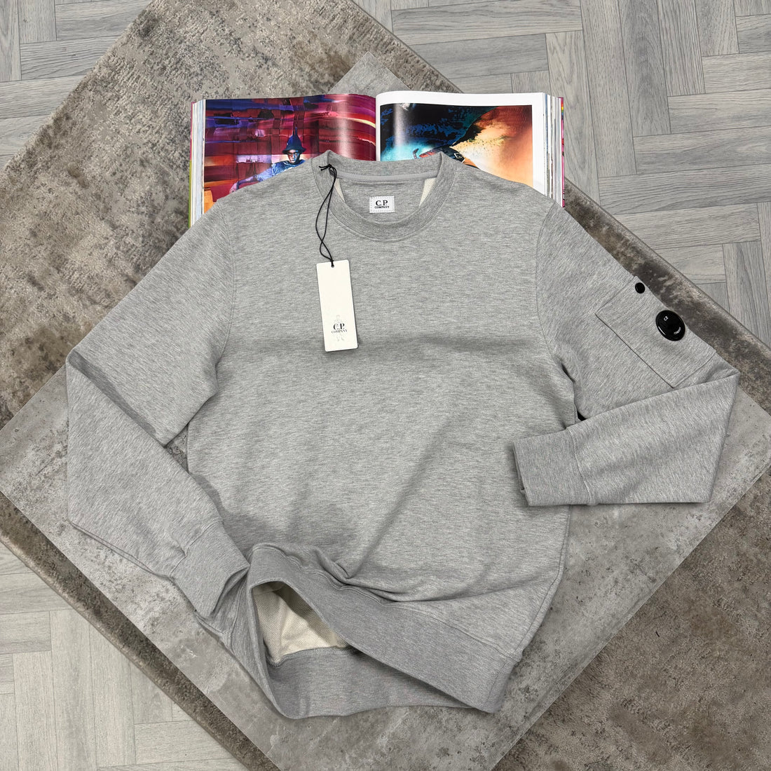 Grey Sweater with black logo in the sleeve
