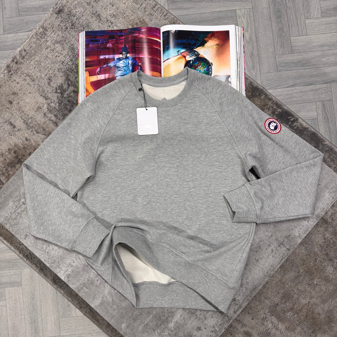 Grey Sweater with red logo in the sleeve