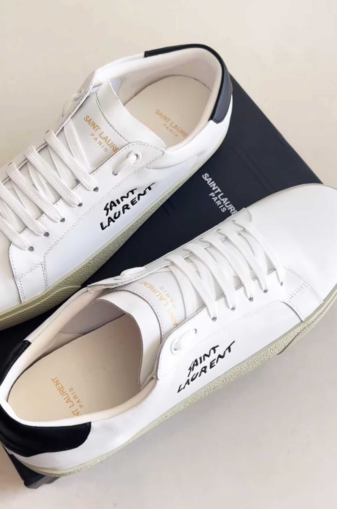 White shoes with brand logo in black